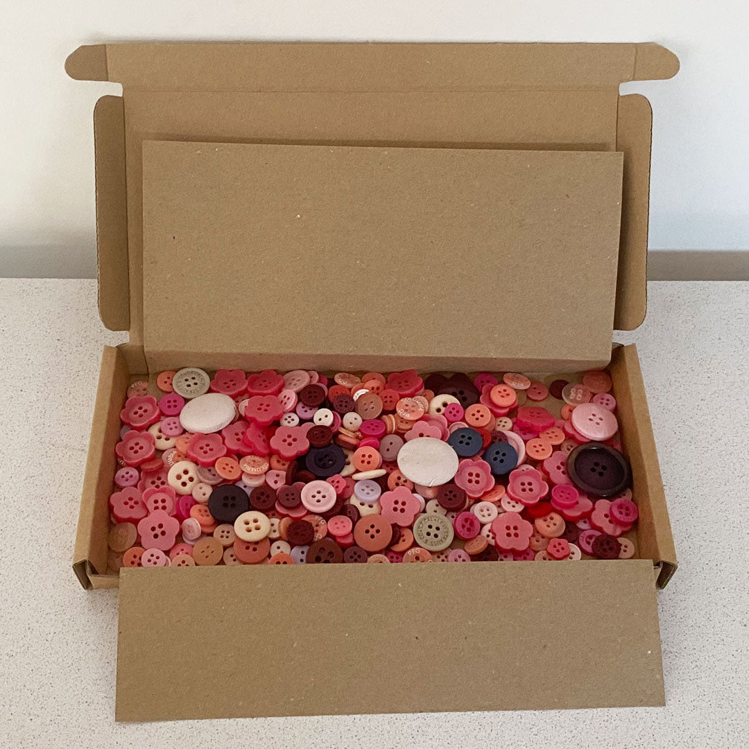 Red vintage and new buttons sorted by colour and sold by weight