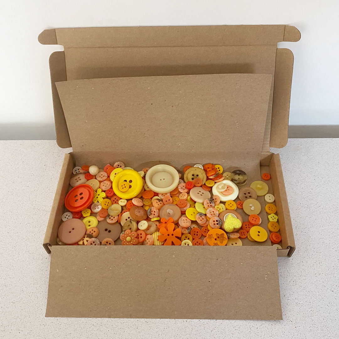 Red vintage and new buttons sorted by colour and sold by weight