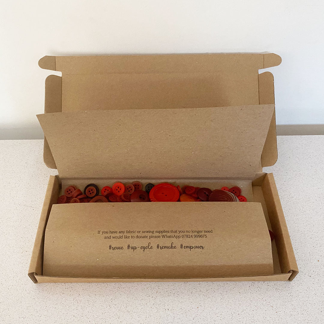 Red vintage and new buttons sorted by colour and sold by weight