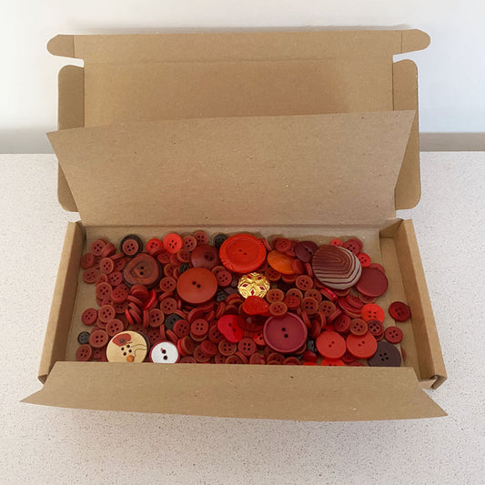 Red vintage and new buttons sorted by colour and sold by weight